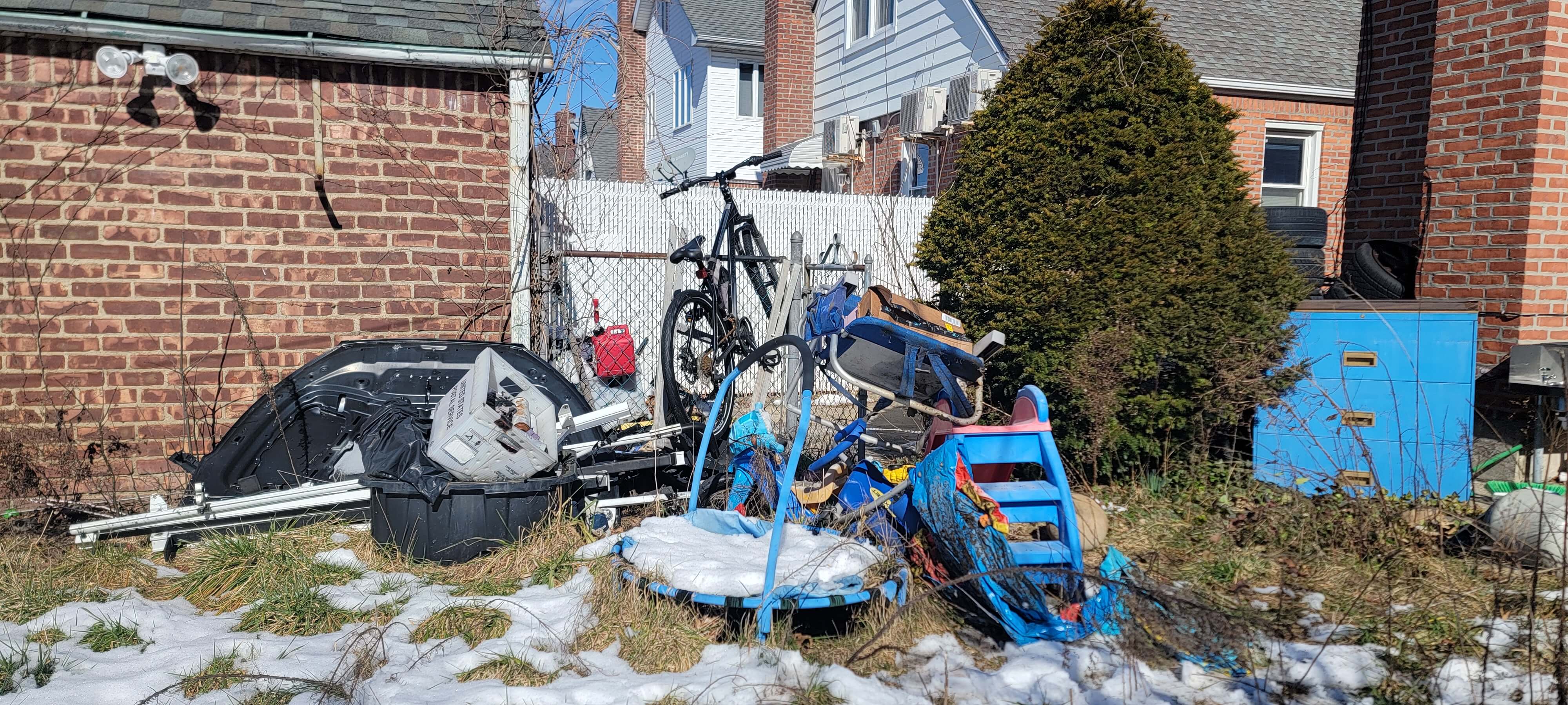 Trash in backyard before removal